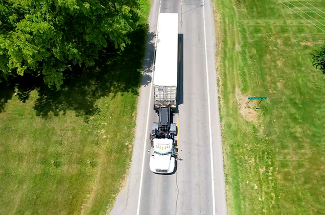Semitruck transporting storage container.