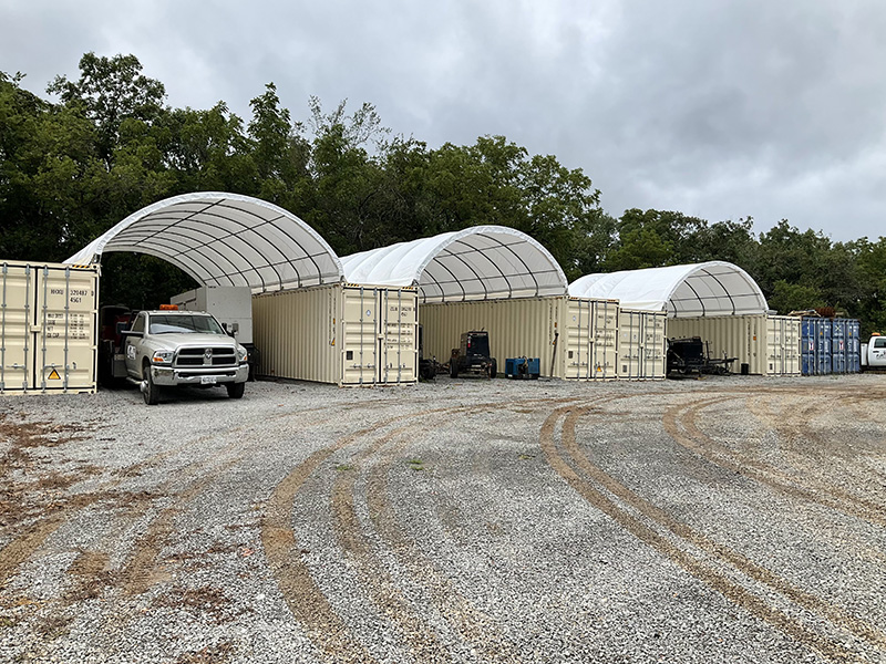 Shipping container canopies create covered work bays for equipment and vehicles—durable, weather-rated shelters with local sales, installation, and mule delivery.